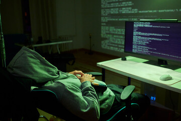 Cybersecurity Analyst Engaged in Writing Code Within a Dimly Lit Environment for Efficiency