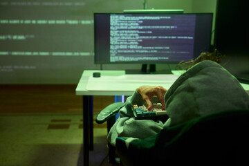 Cybersecurity Analyst Engaged in Writing Code Within a Dimly Lit Environment for Efficiency