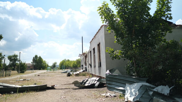 A bombed school with playground on background in the Izum, Ukraine
