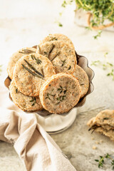Shortbread cheese cookies with aromatic herbs on rustic textured background. Savory parmesan cookies for party
