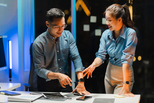 Business Colleagues Discussing Project at Night