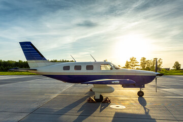 Private turboprop aircraft at the airport in the evening sun