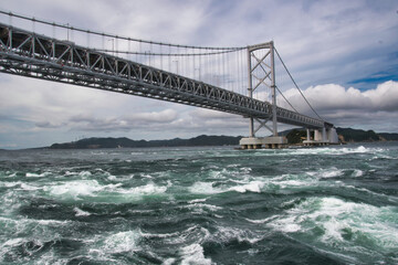 A view of Naruto Sound Bridge and the rough waves.  Japan

