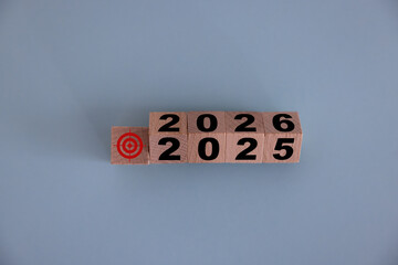 Wooden 2025 to 2026 new year white background. Word 2025 - 2026 wood cube on wooden desk for copy...