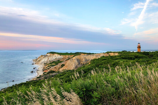 Cliff and lighthouse on Martha's Vineyard beach at sunset
