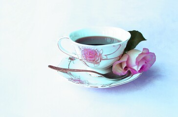 A cup of tea and a rose. Romantic floral arrangement.