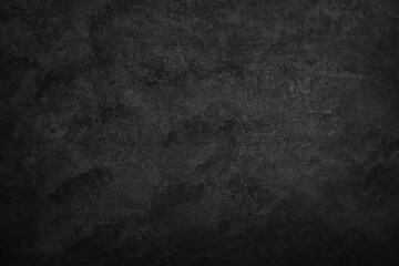 Texture of black polished concrete background. Dark plaster wallpaper with rough cement texture....