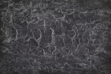 Texture of black polished concrete background. Dark plaster wallpaper with rough cement texture. Empty grunge wall concept or floor backdrop. Abstract surface mockup. Top view, close up, copy space