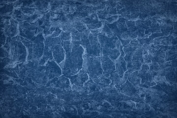 Texture of blue polished concrete background. Dark plaster wallpaper with rough cement texture. Empty grunge wall concept or floor backdrop. Abstract surface mockup. Top view, close up, copy space