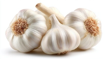 Several fresh garlic bulbs are arranged closely together, showcasing their smooth white skins and textured roots. The lighting accentuates the natural shine and detail of the garlic.