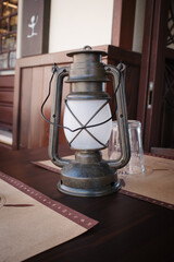 an old lantern stands decoratively on the table