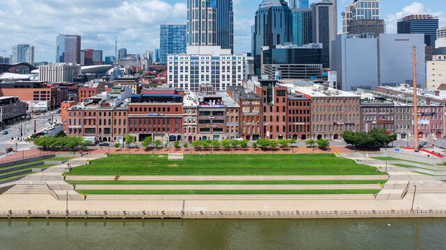 aerial shot of skyscrapers, hotels, office buildings along the riverfront of the Cumberland River in the city skyline in Nashville Tennessee USA