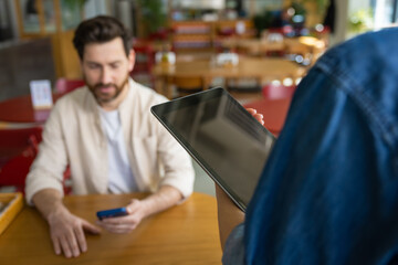 Waiter with tablet waiting for order at restaurant