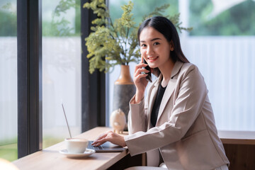asian freelance people Beautiful business female talking making using casual working with laptop computer for browsing internet, chatting and blogging and smartphone,notebook in coffee shop.