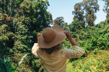 Woman in Straw Hat Admiring Tropical Forest View
