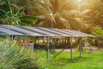 photovoltaic solar power panel for agriculture in a rural houses area Agricultural fields blue sky background,Agro-industry of household Rural style in Thailand, smart farm alternative clean energy.