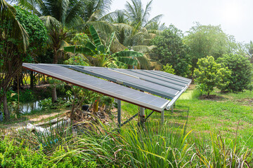 photovoltaic solar power panel for agriculture in a rural houses area Agricultural fields blue sky background,Agro-industry of household Rural style in Thailand, smart farm alternative clean energy.