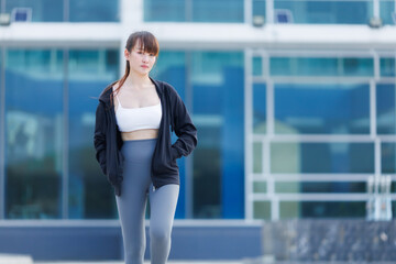 Portrait of beautiful asian Young woman in Black robe sportswear working out outside. training on public equipment in outdoor at park. concept Exercise Healthy lifestyle.