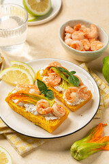 Goumet open Sandwich with pumpkin bread, shrimps, prawns and burrata cheese with Zucchini Flowers or Italian Squash Blossom. Vertical image.