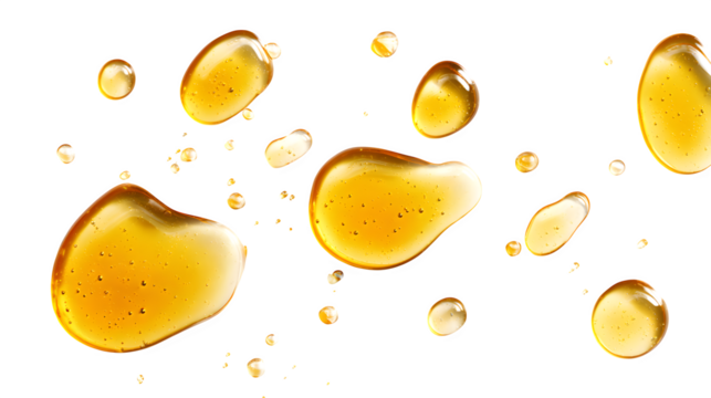 Various drops and puddles of golden honey or syrup, isolated on a clean white background, top view,