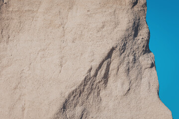 Land formation stands against cerulean skies, creating an ethereal moment of natural beauty and...