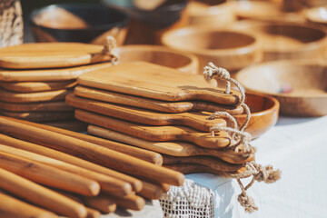 Wooden artistry in the marketplace evokes feelings of simple living and rustic charm on a bright...