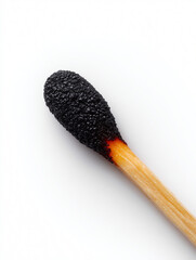 Burnt matchstick with blackened tip on white background
