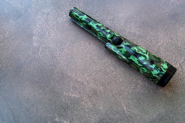 A hand-held metal pinpoint detector in protective color.A device for finding wires in the wall.