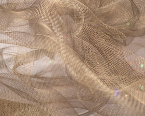 Beige Mesh Fabric with Iridescent Highlights – Abstract Close-Up of Intricate Textile Texture and...