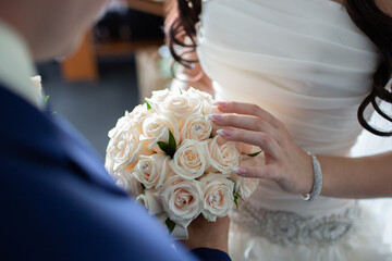 Bride Holding Bouquet of White Roses