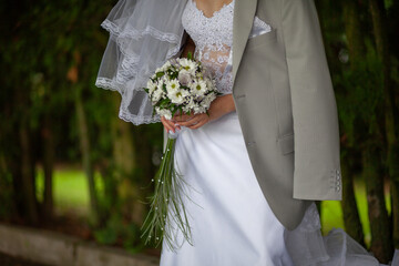 Bride in white gown holding flower bouquet