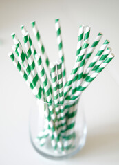 multiple straws in a glass cup