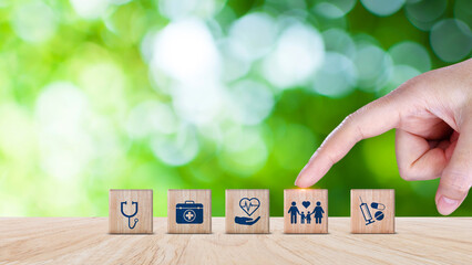 Health Insurance and medical care concept, wooden blocks displaying health related icons, medical care, health insurance, medication. healthcare services, protection, insurance coverage