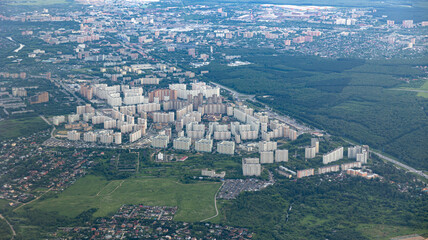 A stunning aerial view depicting urban development beautifully surrounded by lush greenery