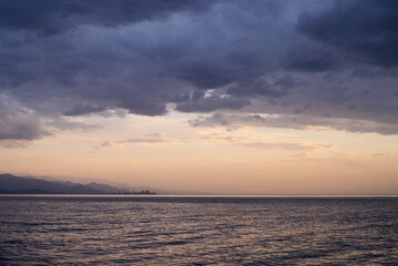 Sea blue cloudy before rain evening landscape. Black sea, sky, mountains and Batumi city are visible on the horizon, Georgia, Adjara