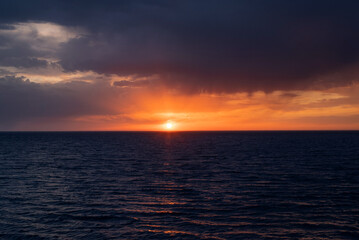 Black sea, dark cloudy stormy sky with rain on horizon, evening landscape.
