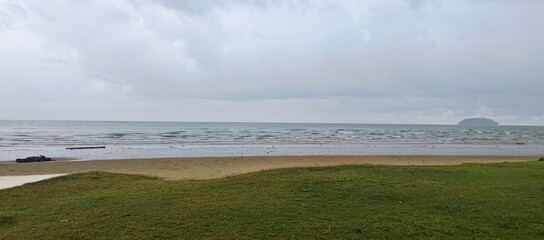Tanjung Aru View from Serene Sandy Shore Under Overcast Skies