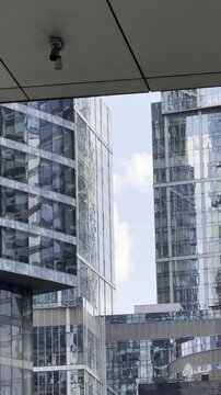 Sky view through tall buildings, Moscow city, clouds, vertical