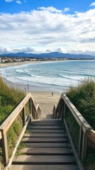 Wooden stairs leading down to a beach with surfers