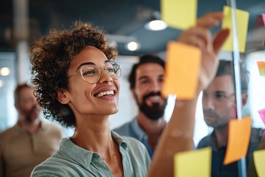 Team members collaborating during a brainstorming session with sticky notes in a modern office
