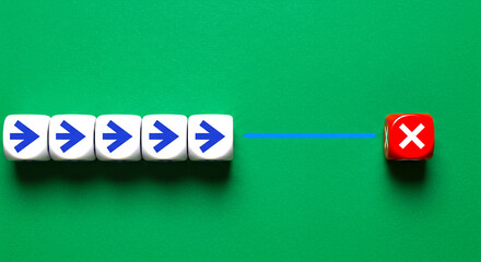 Arrows on white dice pointing towards a red dice with x on a green surface forming a concept