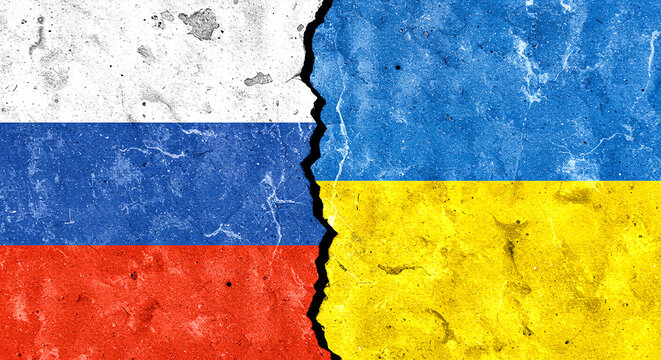 Flags of russia and ukraine painted on cracked wall symbolizing conflict and political tension between nations