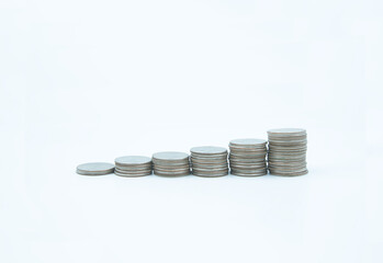 Stacks of coins at different levels of hight, White background