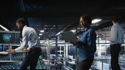 Data center software developers using devices to review AI LLM visualizations. IT professionals...
