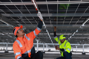 Solar engineer or electrical technician check amp and voltage and connect electrical wiring  of...