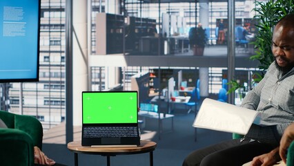 Empowered business CEOs discussing financial strategy with green screen and planning a global partnership between their corporations. Diverse leadership skills and work environment. Camera B.