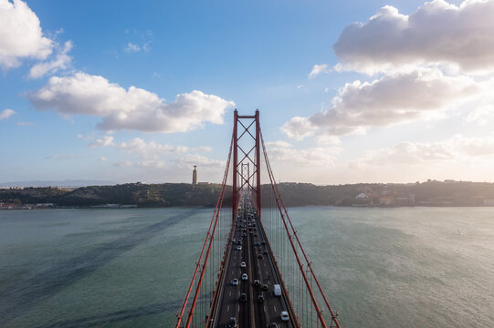 Aerial view of cars crossing the 25 de abril bridge in Lisbon, Portugal. - Powered by Adobe