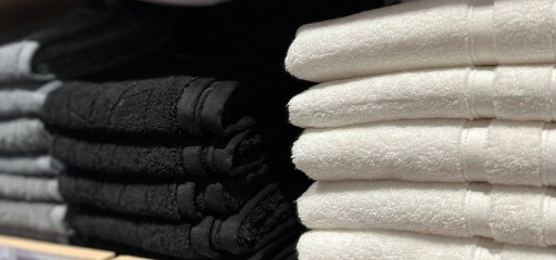 towels on a shelf, assorted towels, towels stacked in a store