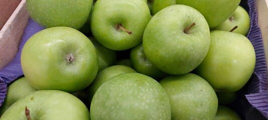 Fresh Green Apples Stacked in an Inviting Store Display Ready for Shoppers to Choose