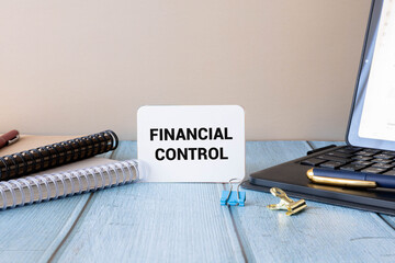 Business man holding wooden blocks sees text: FINANCIAL control.